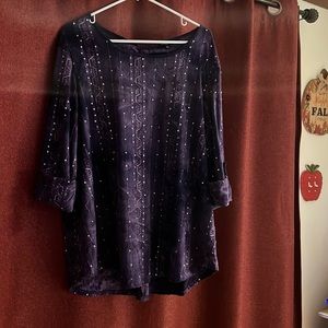 Women’s dress top with three-quarter length sleeves, rolled with a button